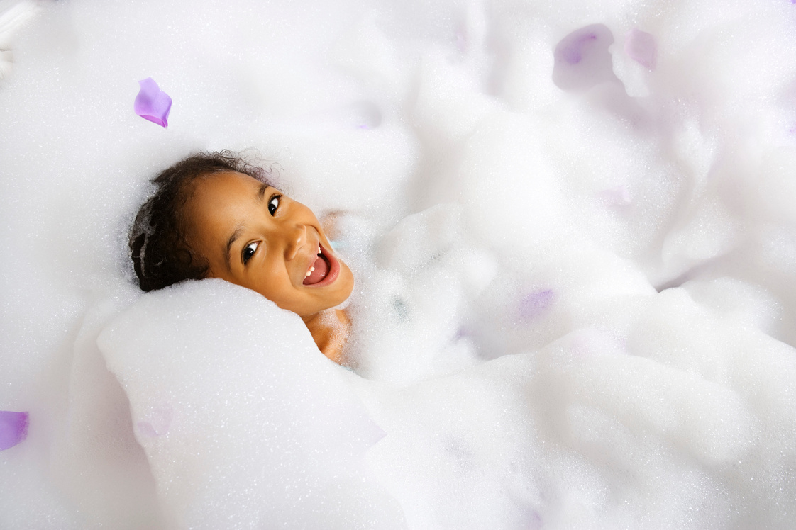 Happy girl in bubble bath